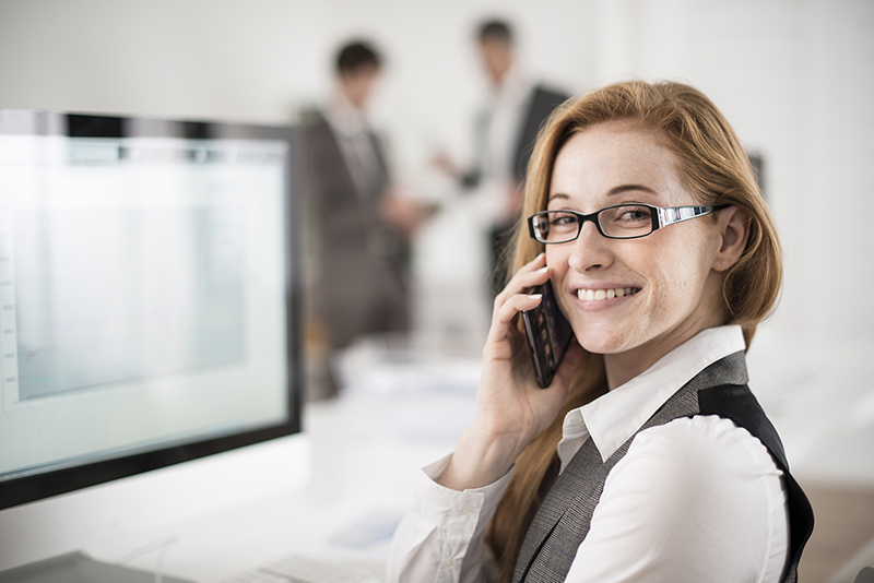 portrait of smiling businesswoman at phone